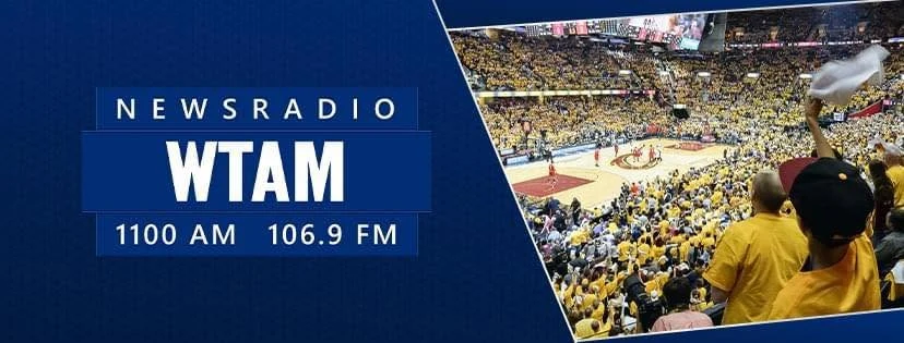 Newsradio WTAM 1100 AM / 106.9 FM banner over a packed Cleveland arena crowd